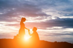 silhouette man ask woman marry mountain background