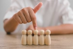 hr manager human resources employers hand chooses take person wooden doll leader stands out from crowd looking good worker hr hrm hrd concepts