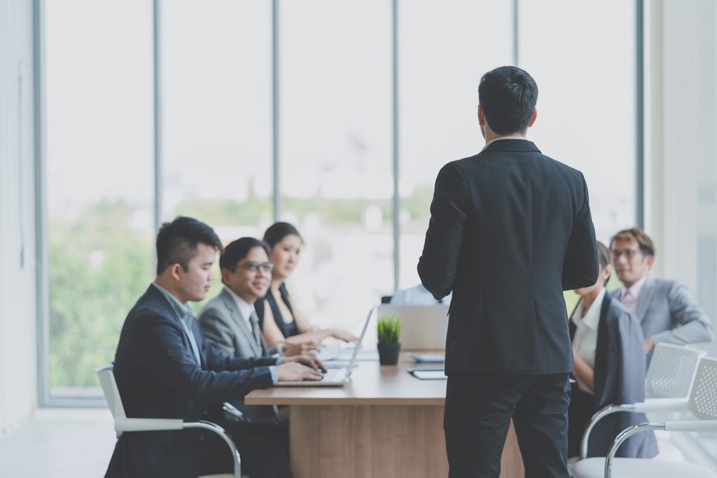 Mengapa Kepemimpinan Membutuhkan Etika businessman leader presenting work while meeting wiht colleagues office business team meeting presentation conference planning business concept